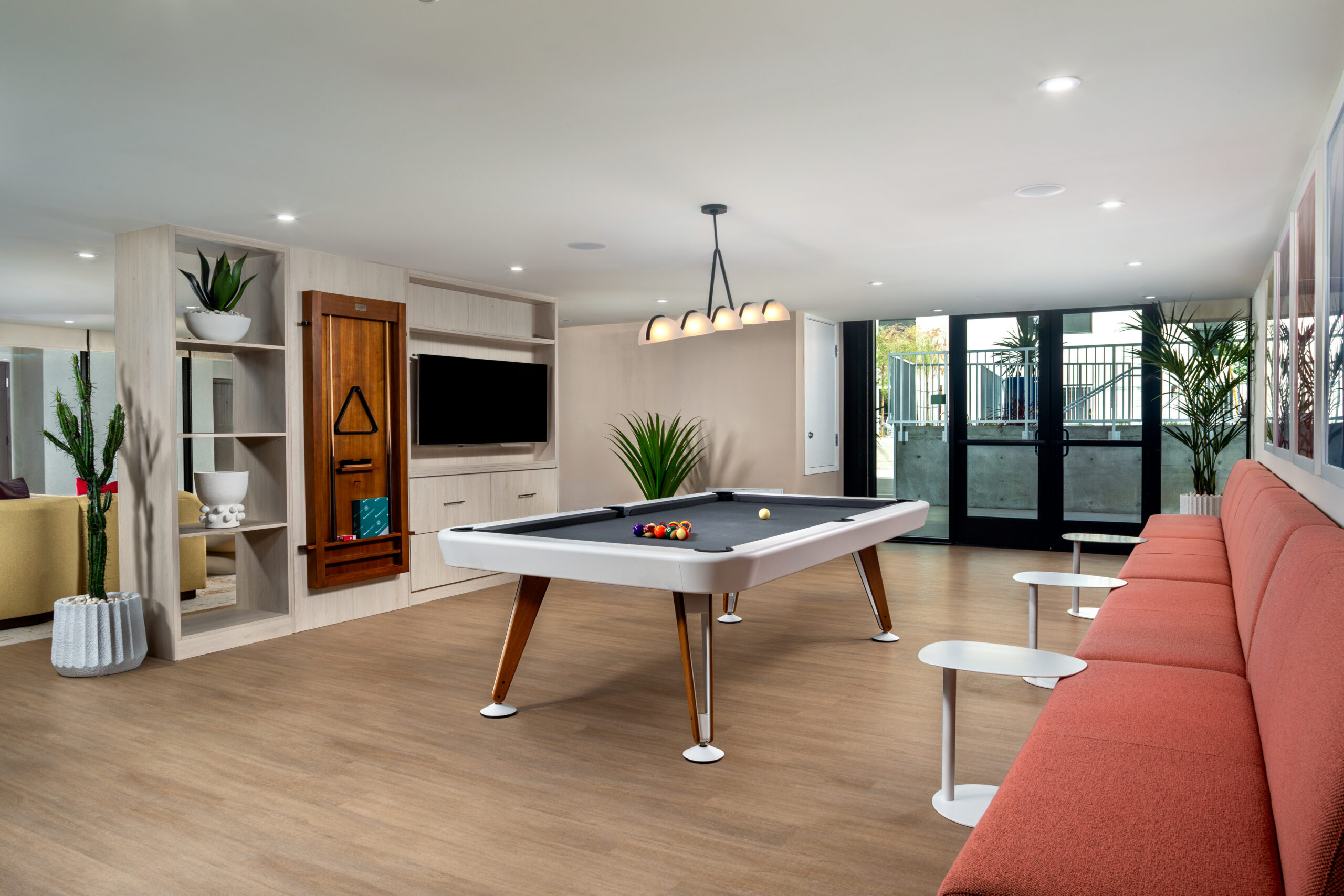 A resident lounge with a couch, pool table, and TV.