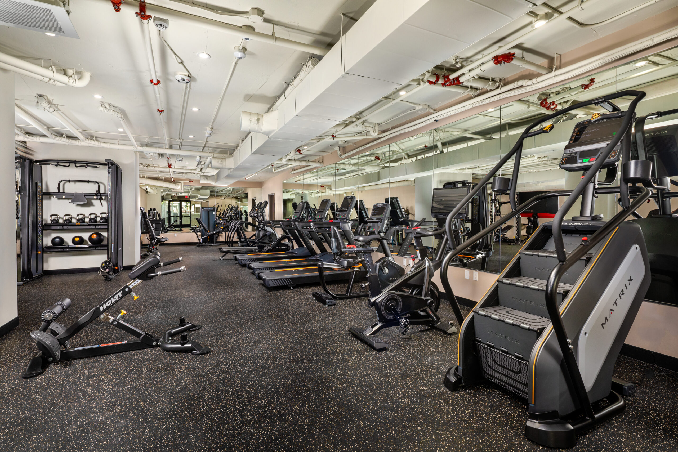 A fitness center with weight and cardio equipment.