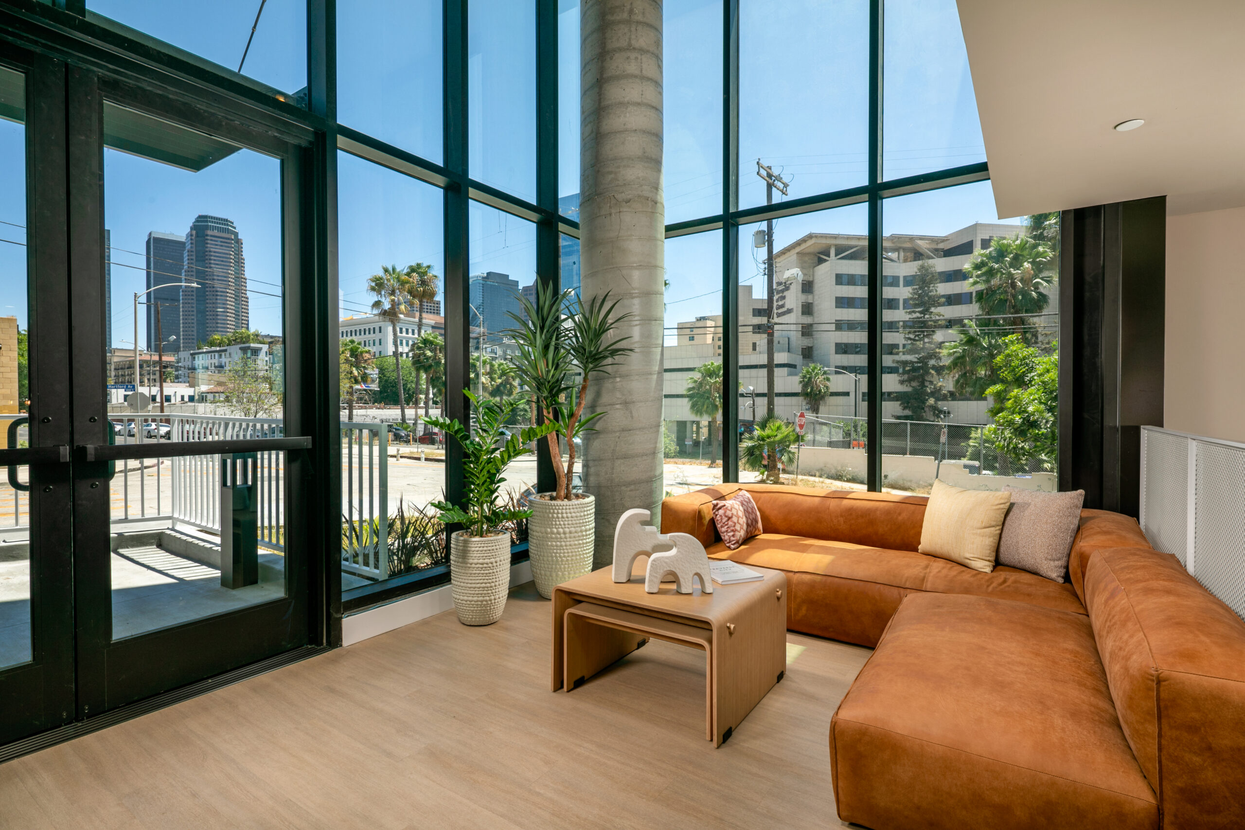 West 5th LA leasing lobby with large windows and a couch and coffee table