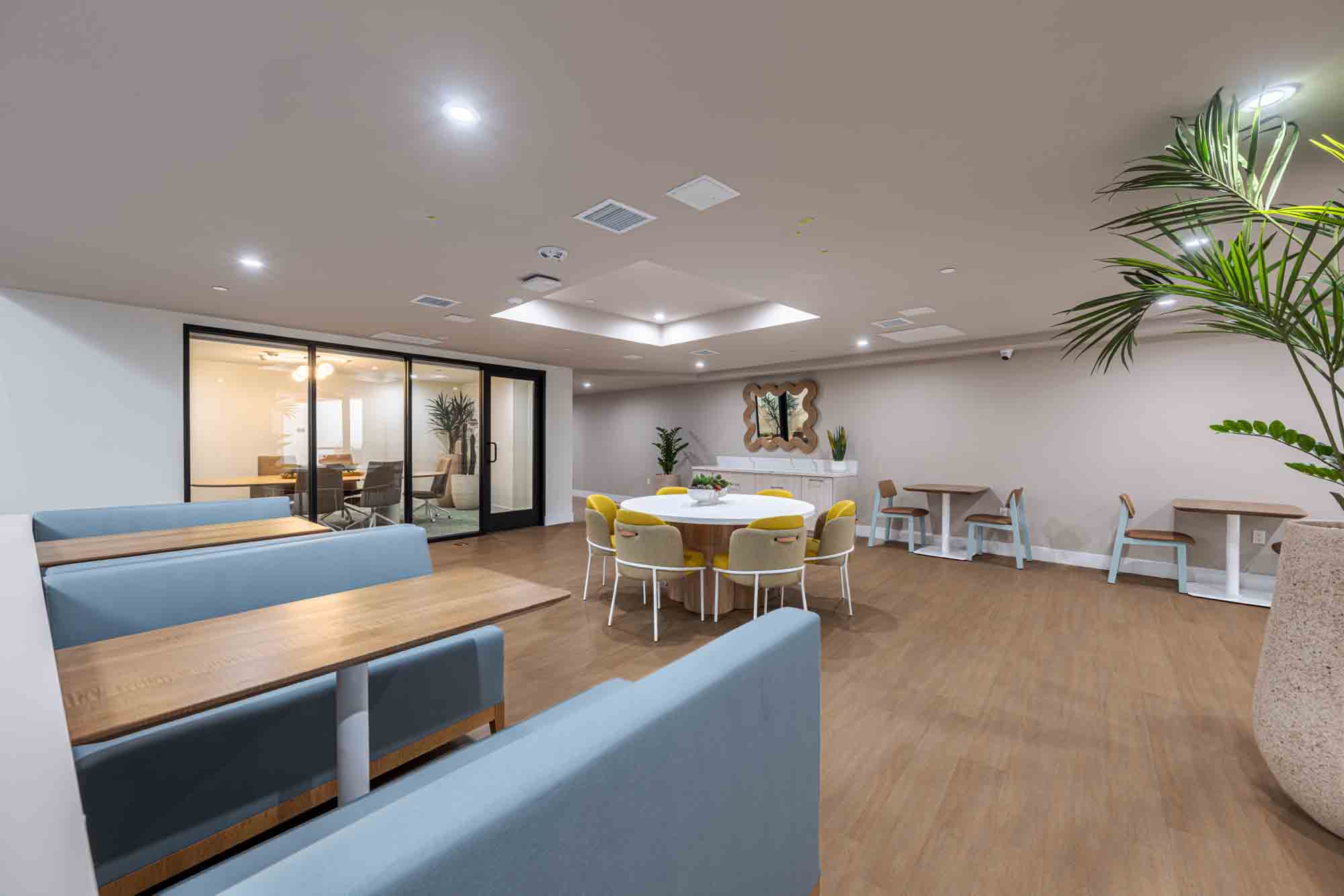 A resident lounge with a table and chairs and couch.