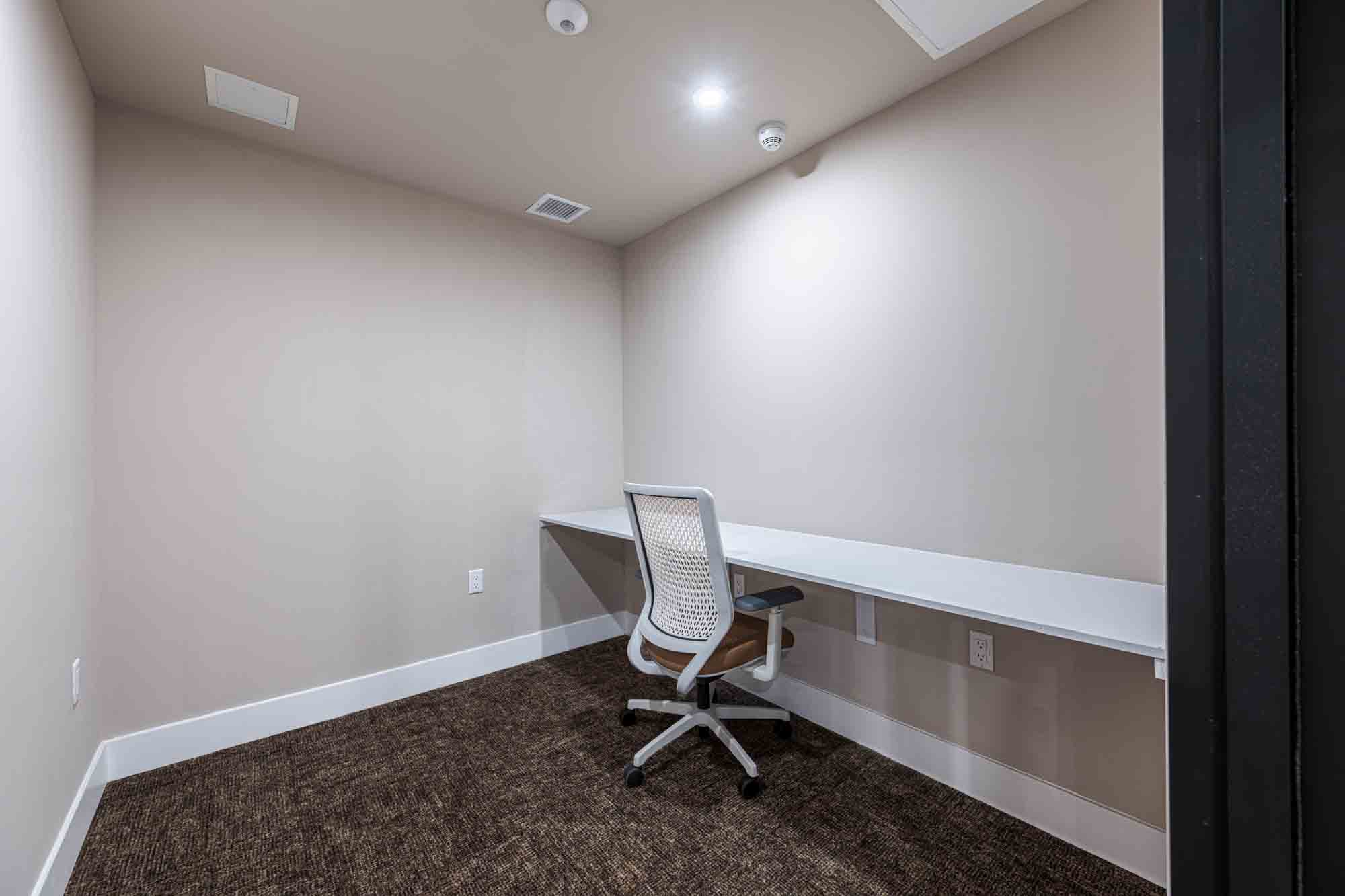 A work from home pod with a desk and chair